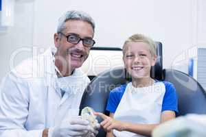 Portrait of smiling dentist and young patient