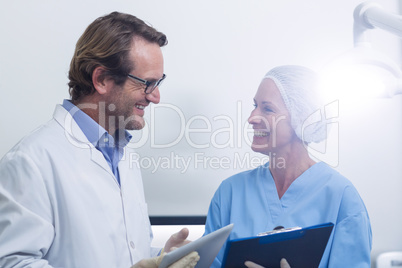 Dentist and dental assistant working on digital tablet