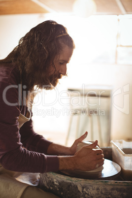 Male potter making pot