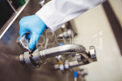 Manufacturer holding pipe in brewery