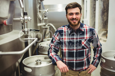 Brewery manufacturer standing by storage tank