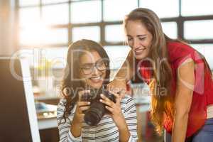 Business executives checking photos in camera