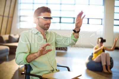 Male business executive using virtual reality video glasses