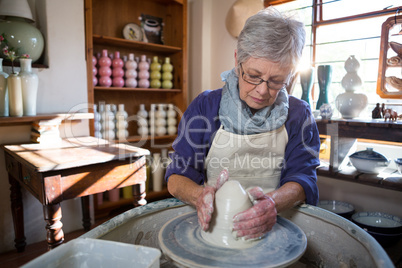Female potter making pot