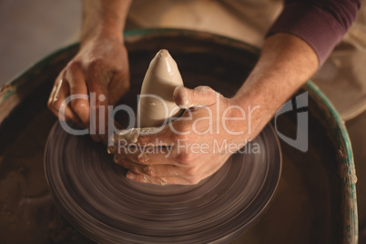 Male potter making pot