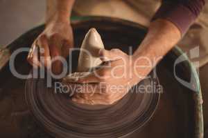 Male potter making pot