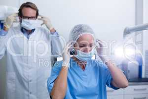 Dentist and dental assistant wearing surgical mask