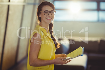 Female business executive holding documents