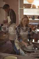 Female potter making pot in pottery workshop