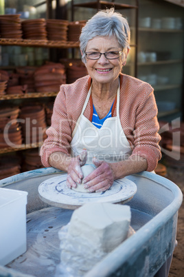 Female potter making pot