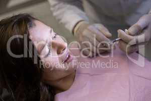 Dentist injecting female patient