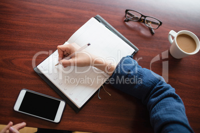 Woman writing in diary