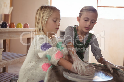 Two girl making pot