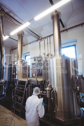 Rear view of manufacturer working in brewery