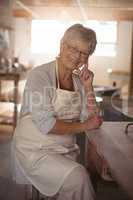 Female potter sitting at table