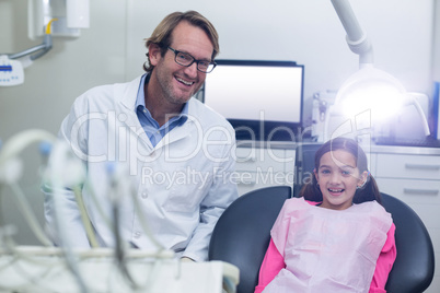 Portrait of smiling dentist and young patient