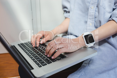 Woman using laptop in locker room