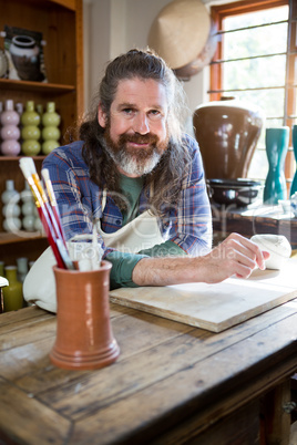 Portrait of male potter in pottery workshop