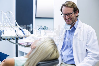 Male dentist interacting with female patient