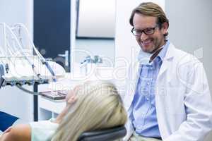 Male dentist interacting with female patient