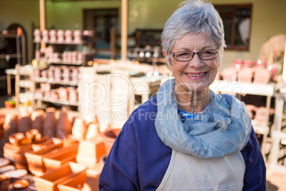 Female potter standing in pottery workshop