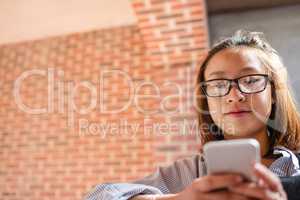 Young woman listening song and using mobile phone