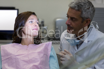 Dentist interacting with female patient