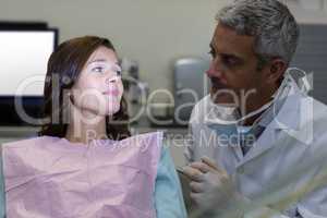 Dentist interacting with female patient