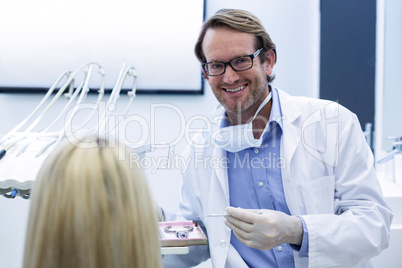 Dentist examining a woman with tools