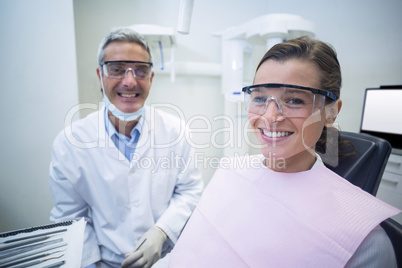 Dentist smiling with female patient