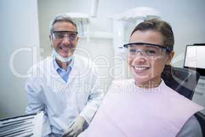 Dentist smiling with female patient