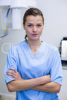 Portrait of dental assistant standing with arms crossed