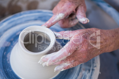 Close-up of potter making pot