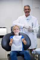 Portrait of smiling dentist and young patient