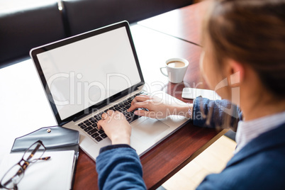 Woman using laptop in college