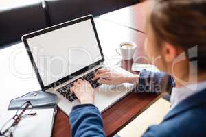 Woman using laptop in college