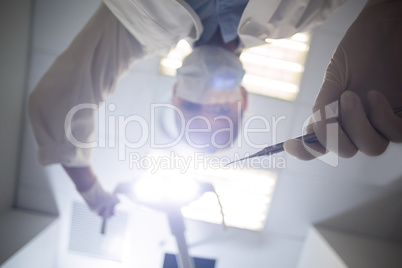 Female dentist holding dental tool