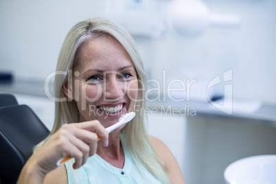 Woman holding tooth brush