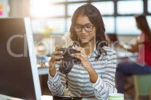 Business executive checking photos in camera