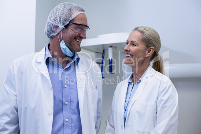 Male and female dentist interacting with each other