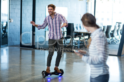 Graphic designer standing on hoverboard