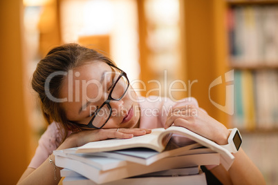 Young woman sleeping in library