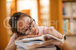 Young woman sleeping in library