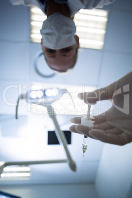 Female dentist holding syringe