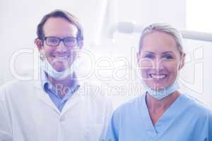 Portrait of dental assistant and dentist wearing surgical mask