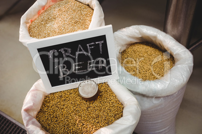 Sign board with various barley in sack at brewery