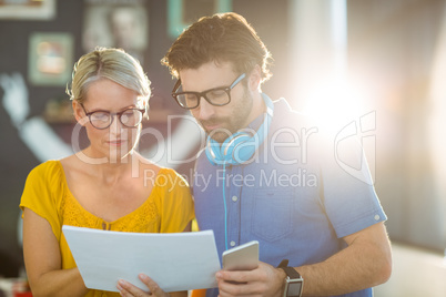 Business executives looking at document