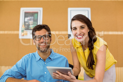 Business executive and co-worker using digital tablet