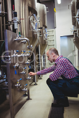 Brewery manufacturer adjusting pressure gauge