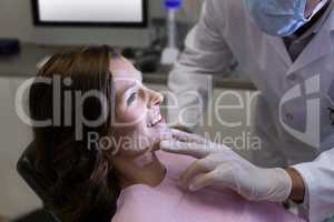 Dentist examining a female patient